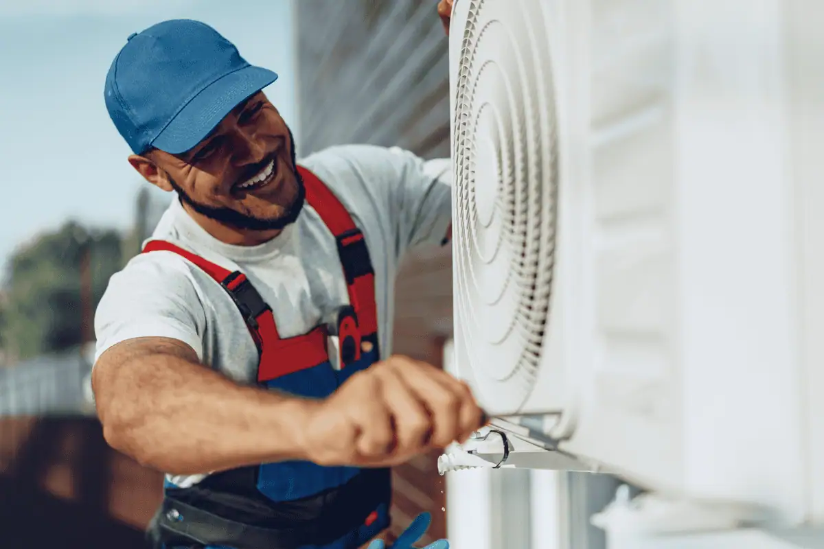 Maintenance worker fixing AC unit