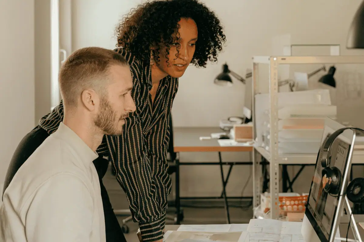 Two people looking at a computer monitor